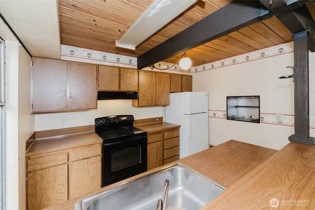 a kitchen with stainless steel appliances a sink a stove and a refrigerator