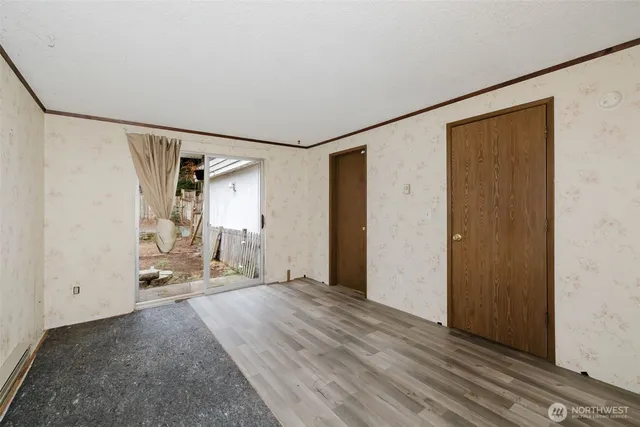a view of an empty room with wooden floor