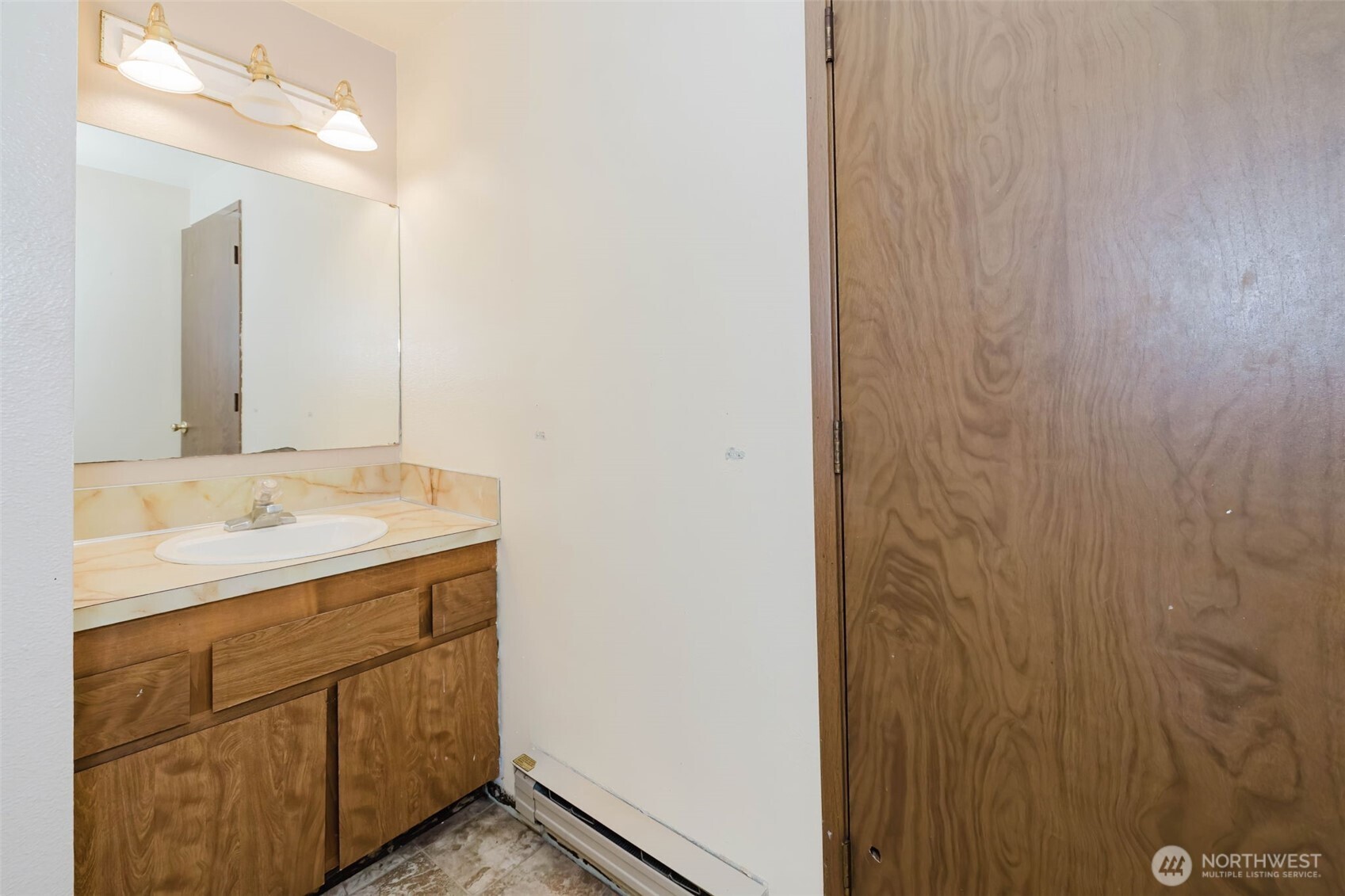 4311 67th Avenue West, Unit B Tacoma, WA 98466 - Photo 25 of 39 a bathroom with a sink and a mirror
