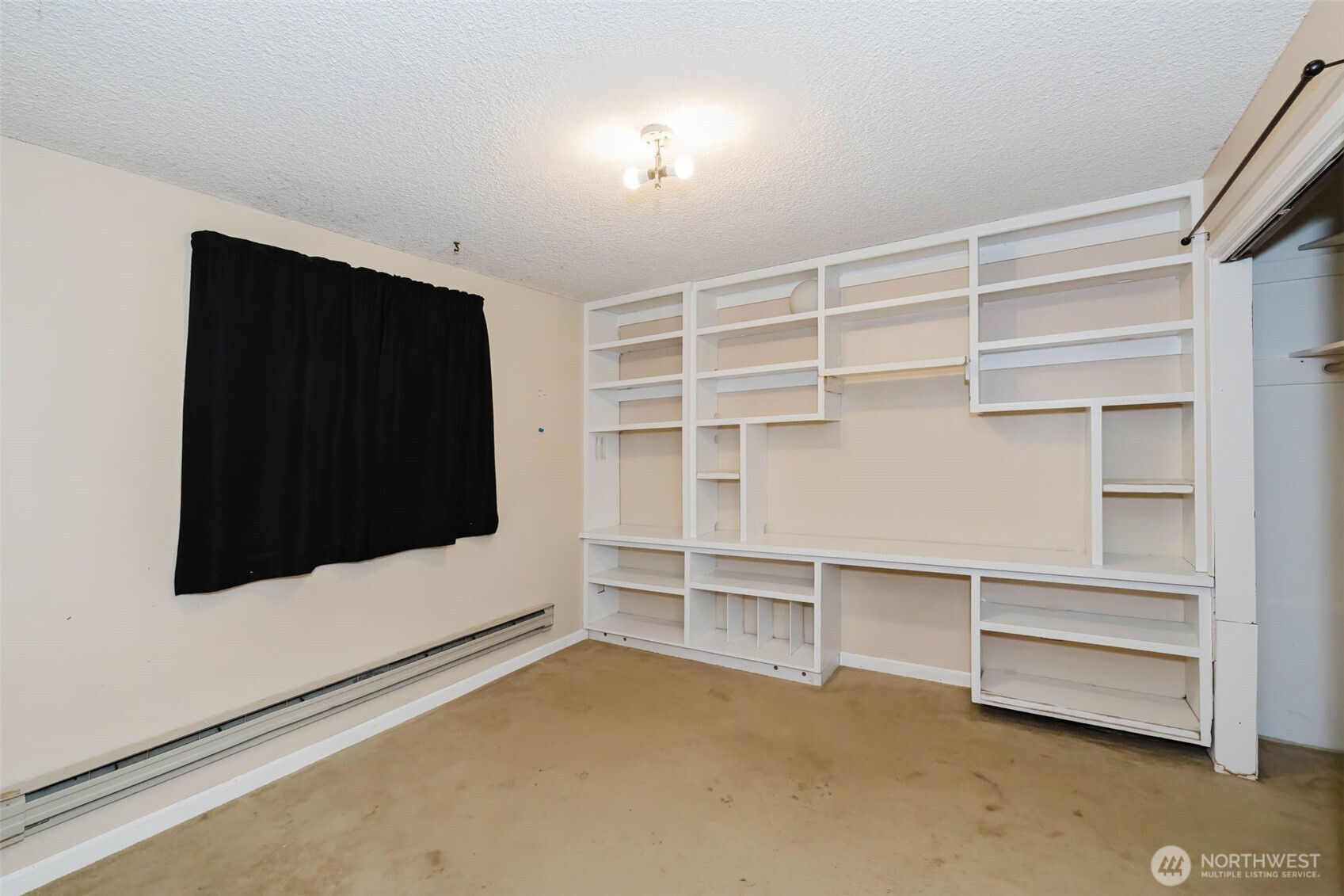4311 67th Avenue West, Unit B Tacoma, WA 98466 - Photo 34 of 39 a view of an empty room with wooden cabinet and windows