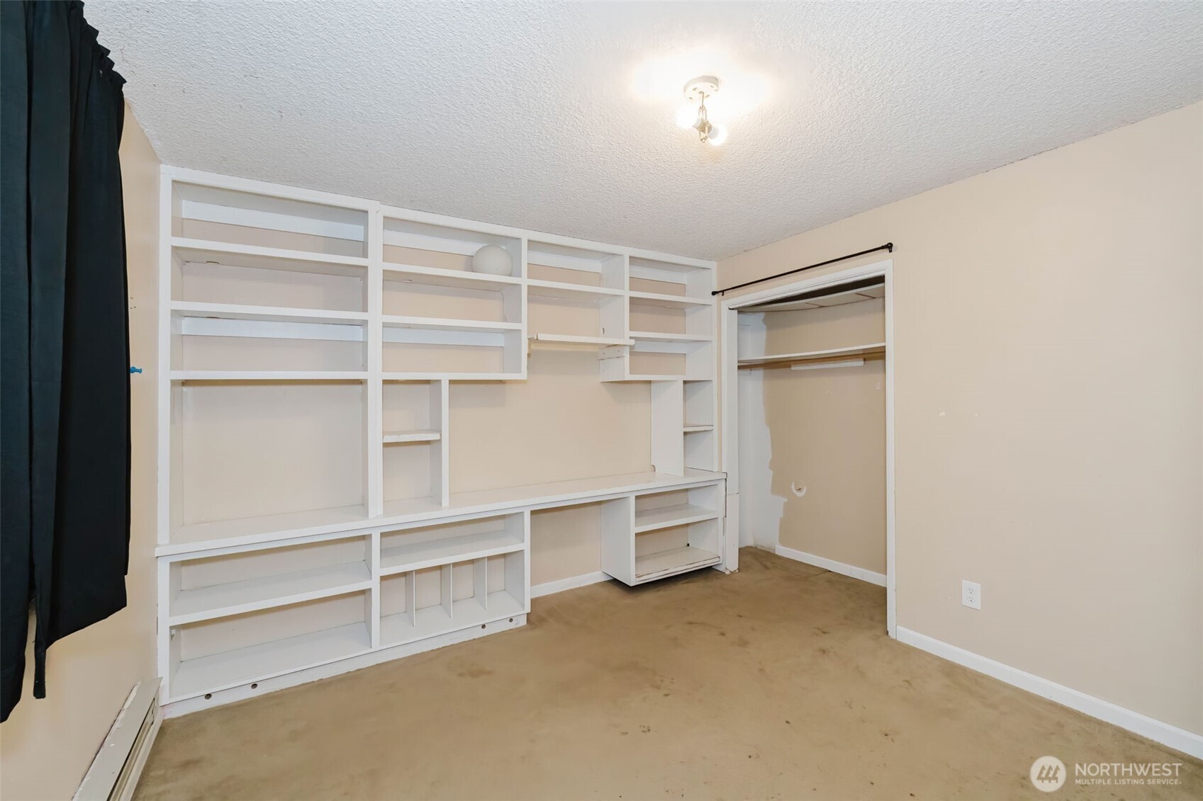 4311 67th Avenue West, Unit B Tacoma, WA 98466 - Photo 35 of 39 a view of walk in closet with empty racks