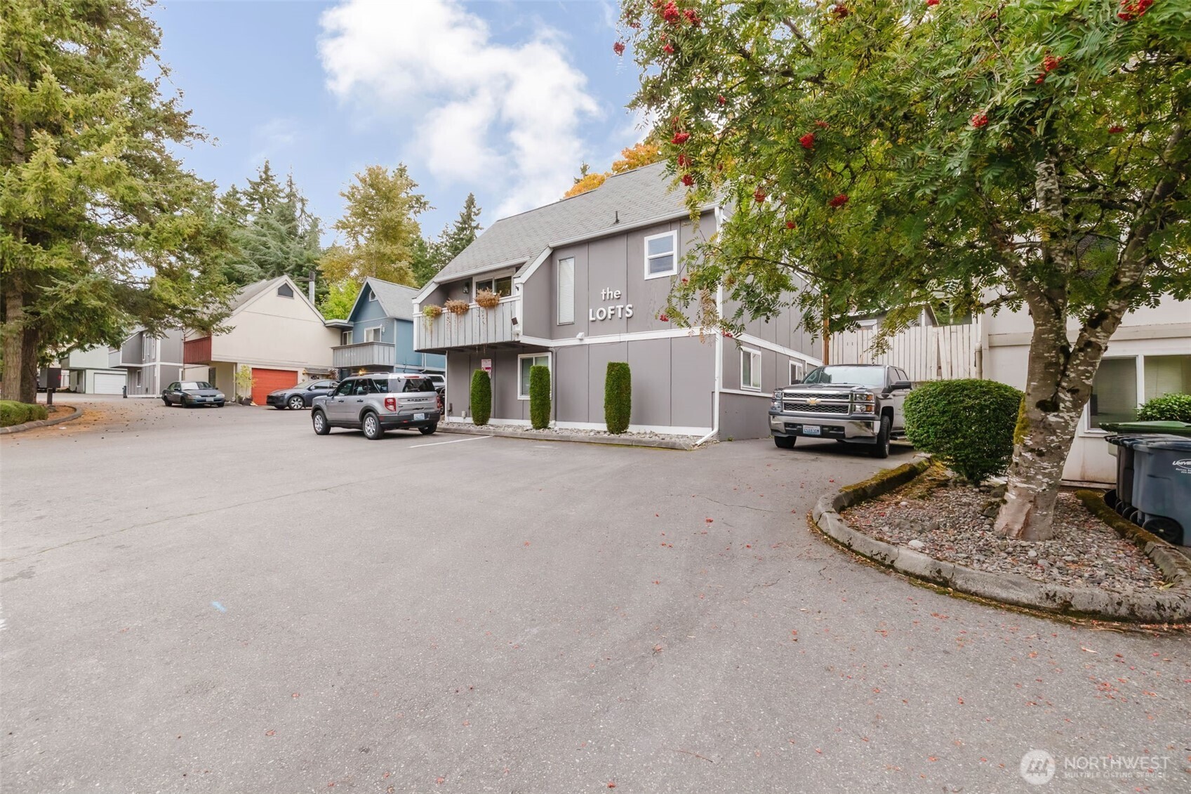 4311 67th Avenue West, Unit B Tacoma, WA 98466 - Photo 4 of 39 a view of road with card parked on side and retail shops