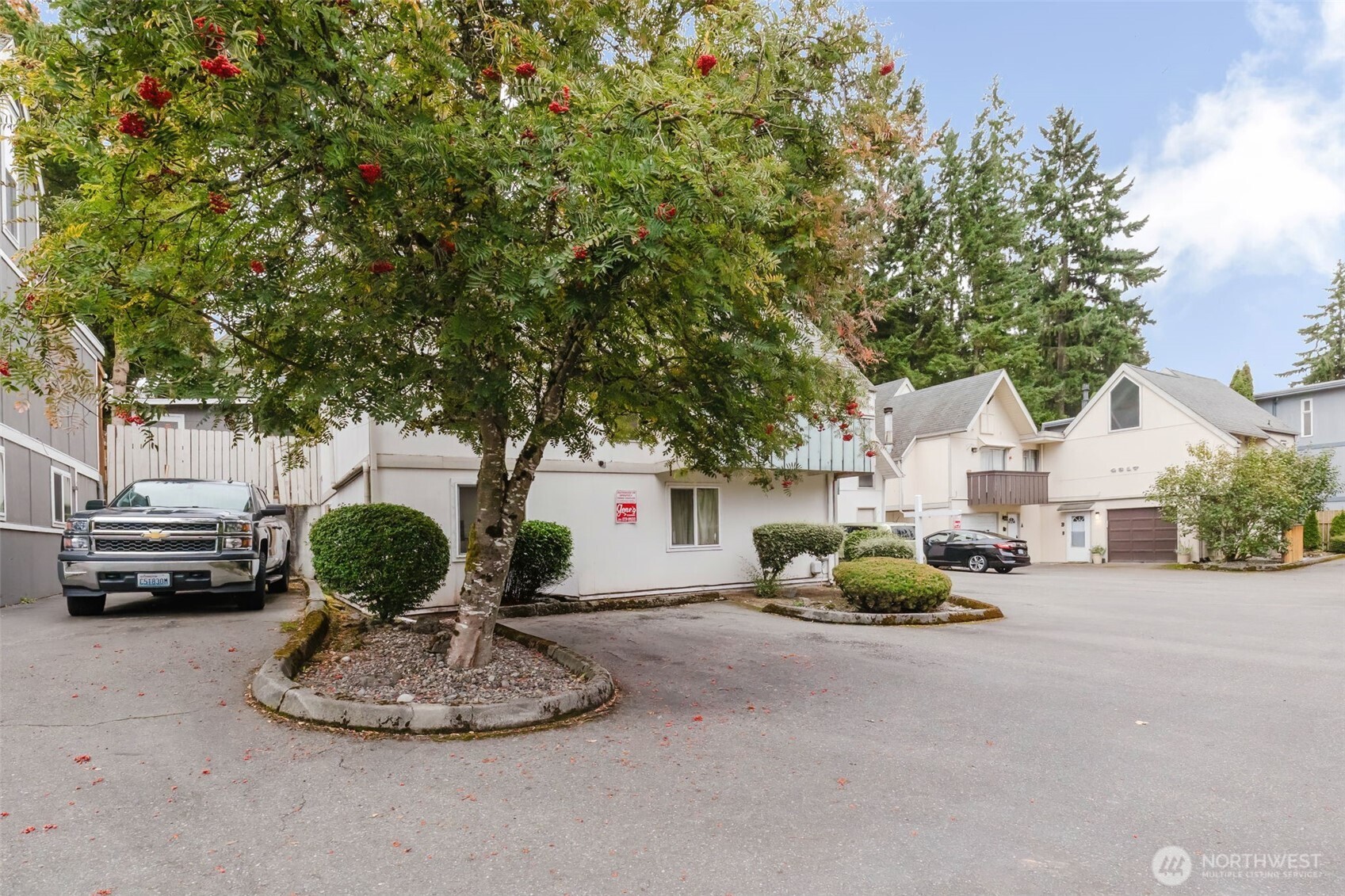 4311 67th Avenue West, Unit B Tacoma, WA 98466 - Photo 5 of 39 a view of a back yard of the house with parked cars