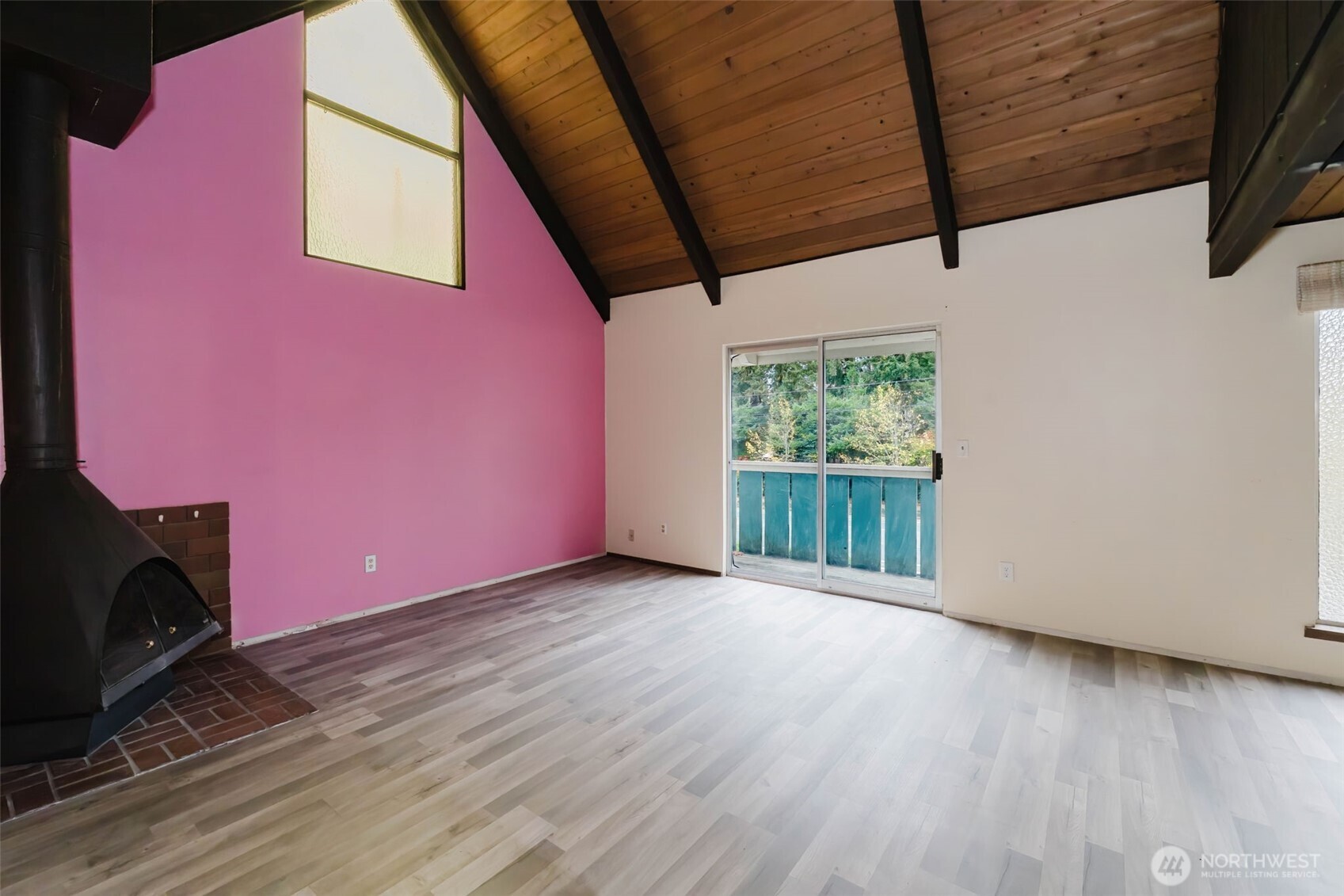 4311 67th Avenue West, Unit B Tacoma, WA 98466 - Photo 8 of 39 a view of an empty room with wooden floor and a window