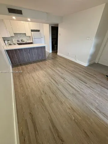 a view of kitchen with wooden floor