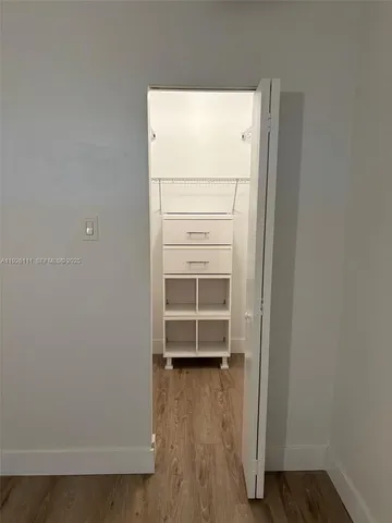 a view of a room with wooden floor