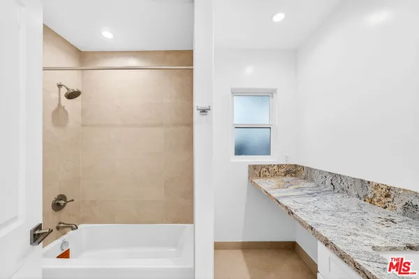 a bathroom with a tub and a shower
