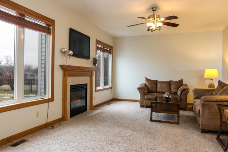 10815 Chicory Ridge Way Roscoe, IL 61073 - Photo 11 of 25 a living room with furniture and a fireplace