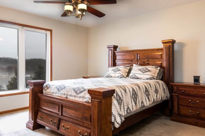 10815 Chicory Ridge Way Roscoe, IL 61073 - Photo 13 of 25 a bedroom with a bed and a chandelier