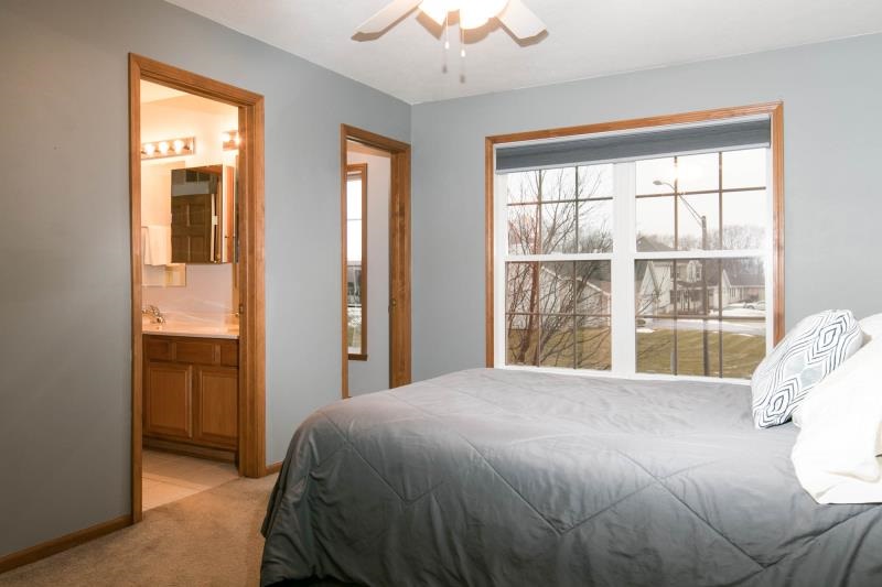 10815 Chicory Ridge Way Roscoe, IL 61073 - Photo 17 of 25 a bed sitting in a bedroom next to a window