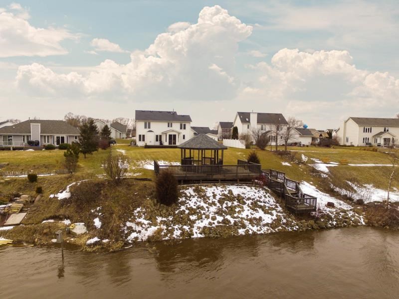 10815 Chicory Ridge Way Roscoe, IL 61073 - Photo 2 of 25 a view of a lake with houses