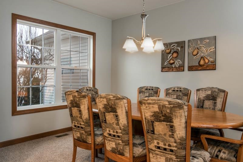 10815 Chicory Ridge Way Roscoe, IL 61073 - Photo 7 of 25 a view of a dining room with furniture and chandelier