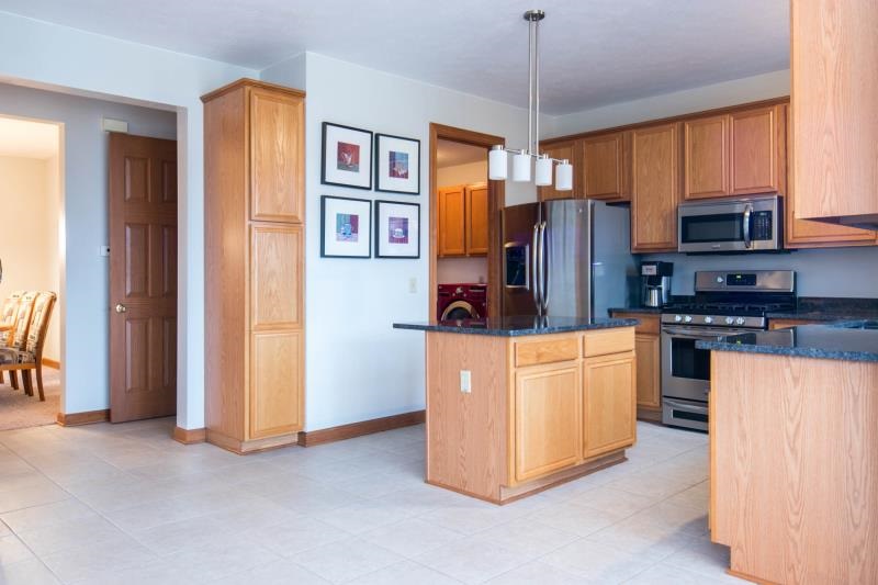 10815 Chicory Ridge Way Roscoe, IL 61073 - Photo 8 of 25 a kitchen with stainless steel appliances granite countertop a refrigerator and a stove top oven