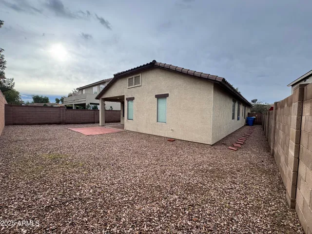 a view of a house with a backyard