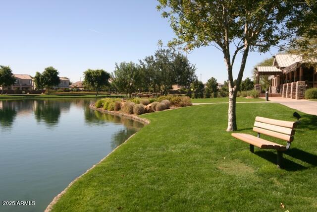 4554 East Sundance Avenue Gilbert, AZ 85297 - Photo 18 of 21 a view of a lake with couches and wooden fence