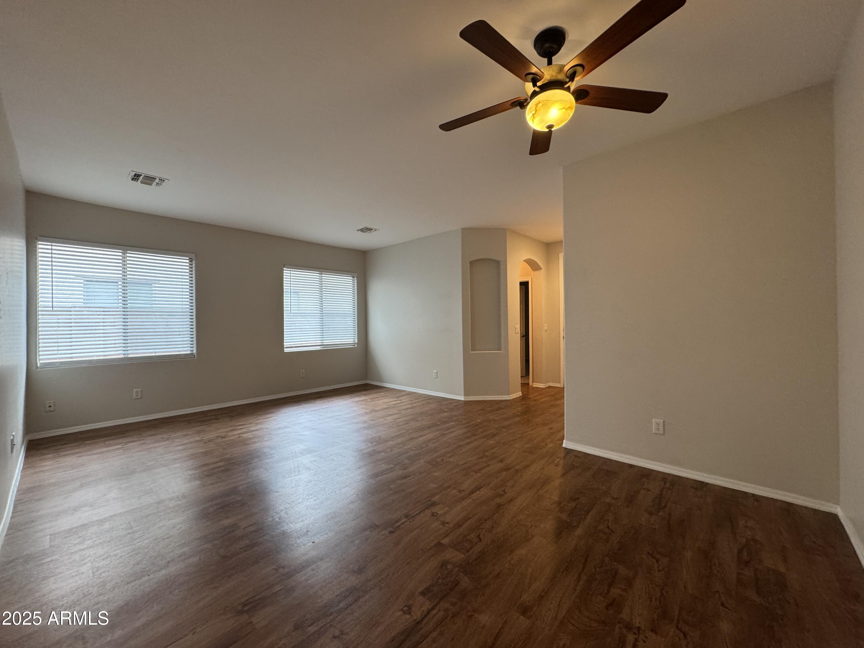 4554 East Sundance Avenue Gilbert, AZ 85297 - Photo 2 of 21 a view of an empty room with a window and wooden floor