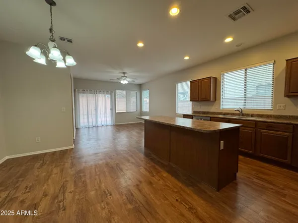 a kitchen with stainless steel appliances granite countertop a sink refrigerator and microwave