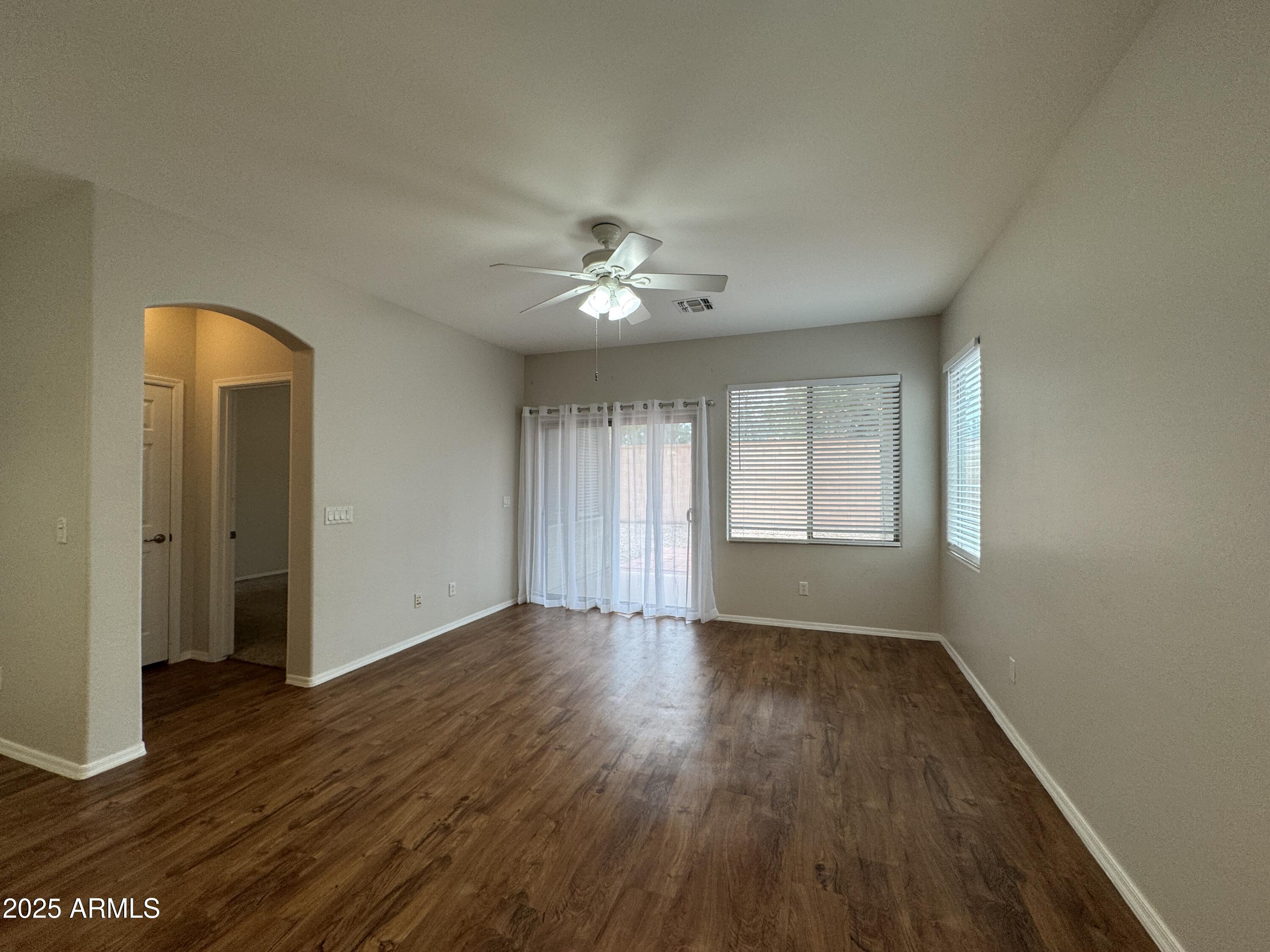 4554 East Sundance Avenue Gilbert, AZ 85297 - Photo 5 of 21 an empty room with wooden floor and windows