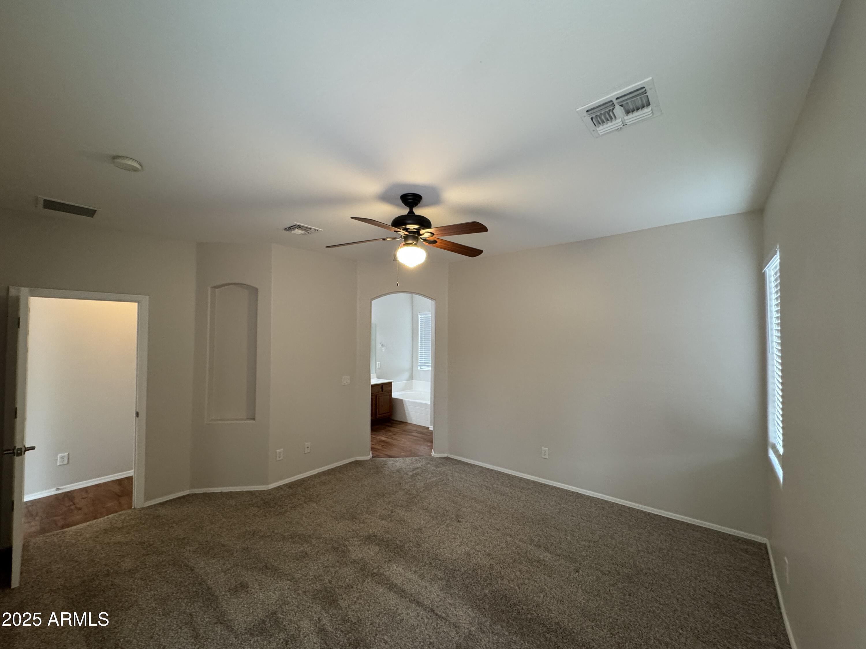 4554 East Sundance Avenue Gilbert, AZ 85297 - Photo 6 of 21 an empty room with closet and a chandelier fan