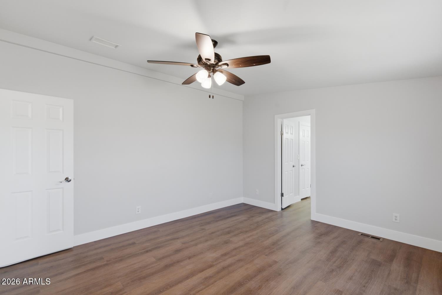 23317 South 180th Street Gilbert, AZ 85298 - Photo 27 of 36 an empty room with wooden floor ceiling fan and window
