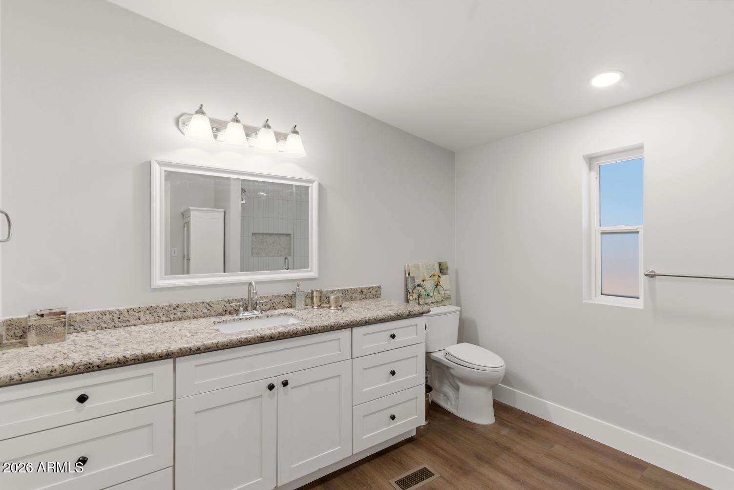 23317 South 180th Street Gilbert, AZ 85298 - Photo 30 of 36 a bathroom with a granite countertop sink mirror and toilet