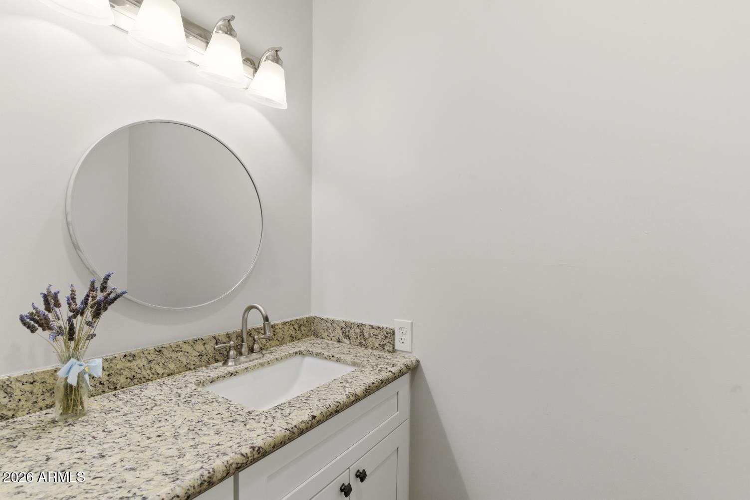 23317 South 180th Street Gilbert, AZ 85298 - Photo 31 of 36 a bathroom with a granite countertop sink and a mirror