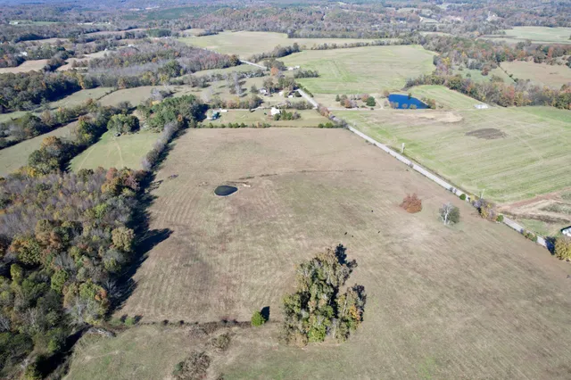 an aerial view of mountain with yard