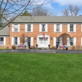 a front view of house with yard and outdoor seating