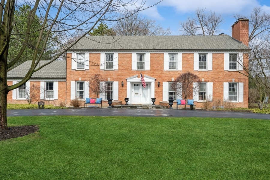 a front view of house with yard and outdoor seating