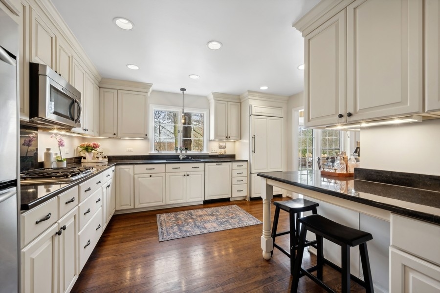 34 Longmeadow Road Winnetka, IL 60093 - Photo 11 of 35 a large kitchen with granite countertop lots of counter space and wooden floor