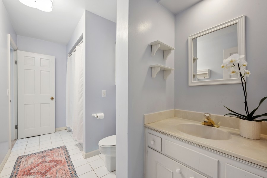 34 Longmeadow Road Winnetka, IL 60093 - Photo 23 of 35 a bathroom with a sink a toilet and shower