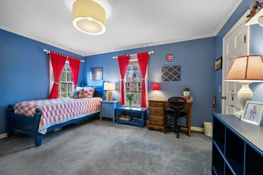 34 Longmeadow Road Winnetka, IL 60093 - Photo 24 of 35 a bedroom with a bed and a chandelier