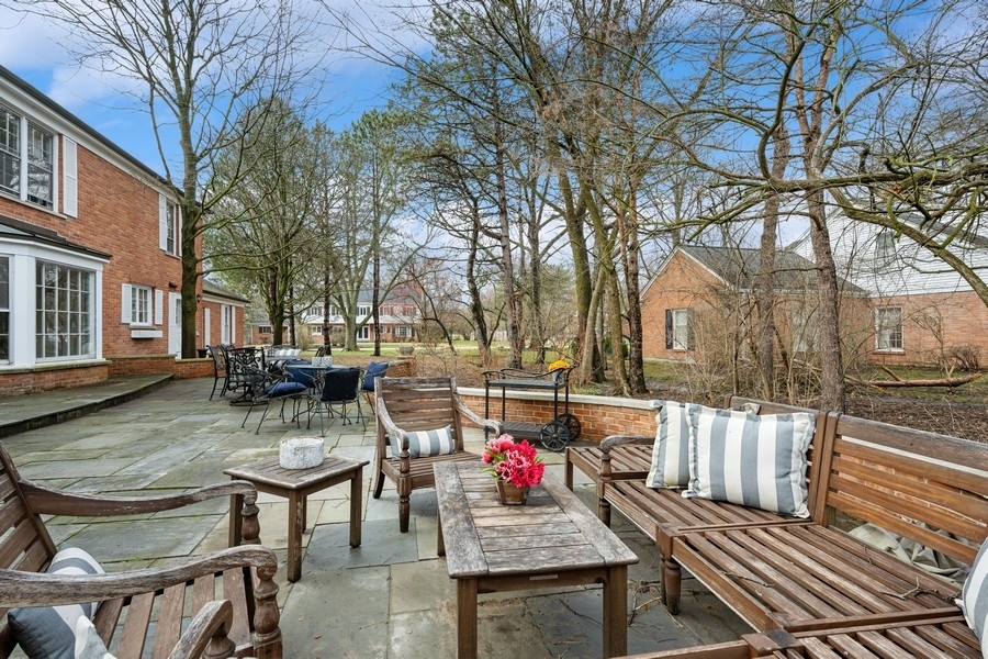 34 Longmeadow Road Winnetka, IL 60093 - Photo 32 of 35 a view of a patio with table and chairs and potted plants