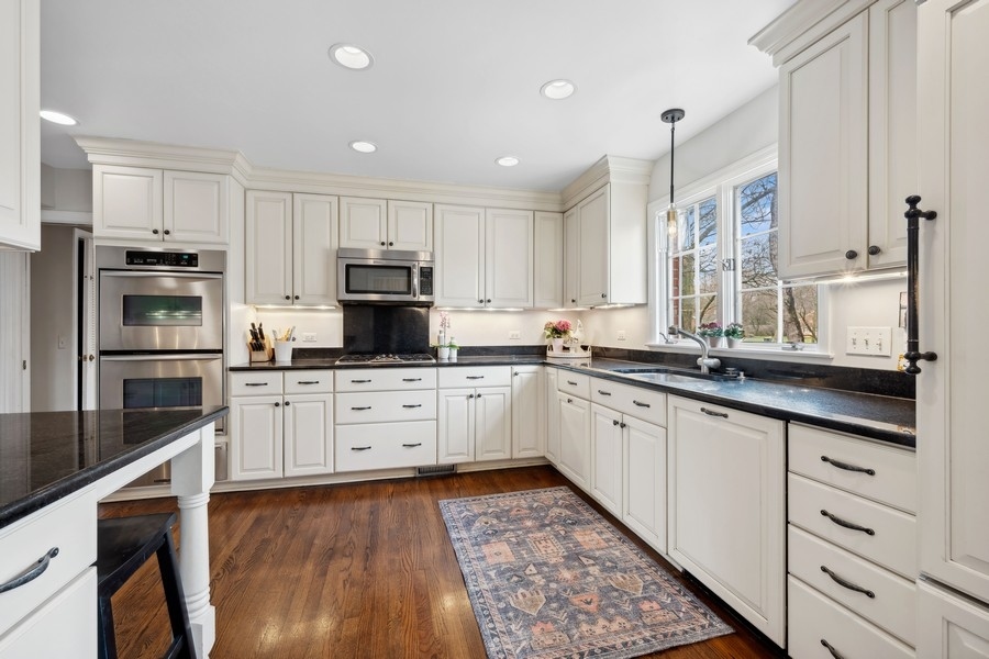 34 Longmeadow Road Winnetka, IL 60093 - Photo 10 of 35 a kitchen with granite countertop white cabinets and stainless steel appliances