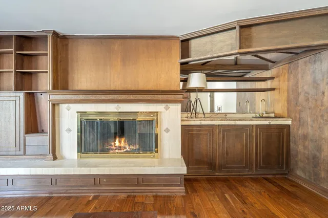 a living room with a fireplace and a wooden floor