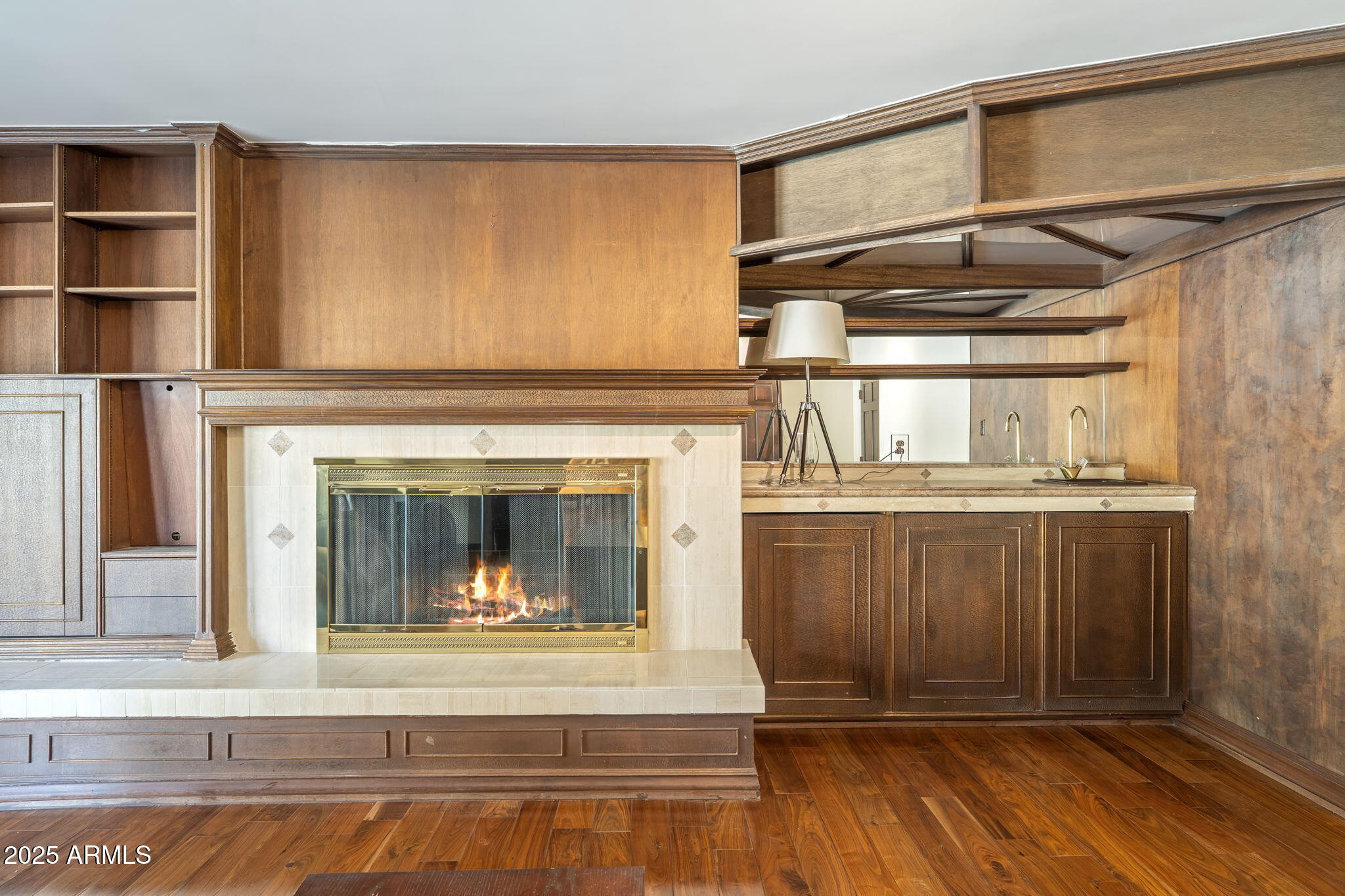 5310 East Camelback Road Phoenix, AZ 85018 - Photo 14 of 50 a living room with a fireplace and a wooden floor