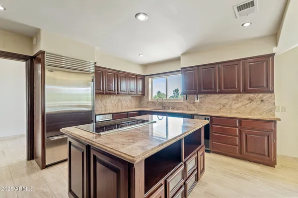 a kitchen with granite countertop a sink and cabinets