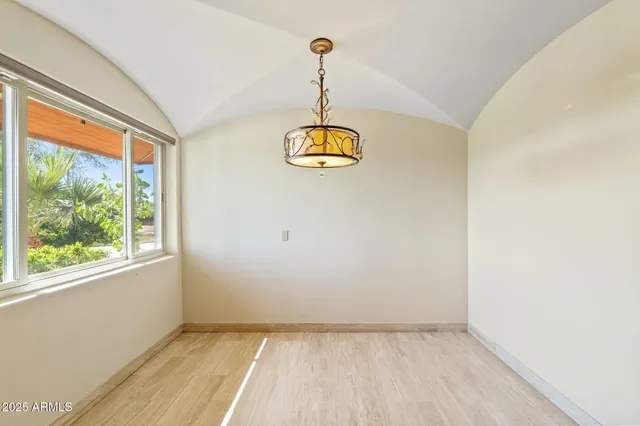 a view of a room with window and wooden floor