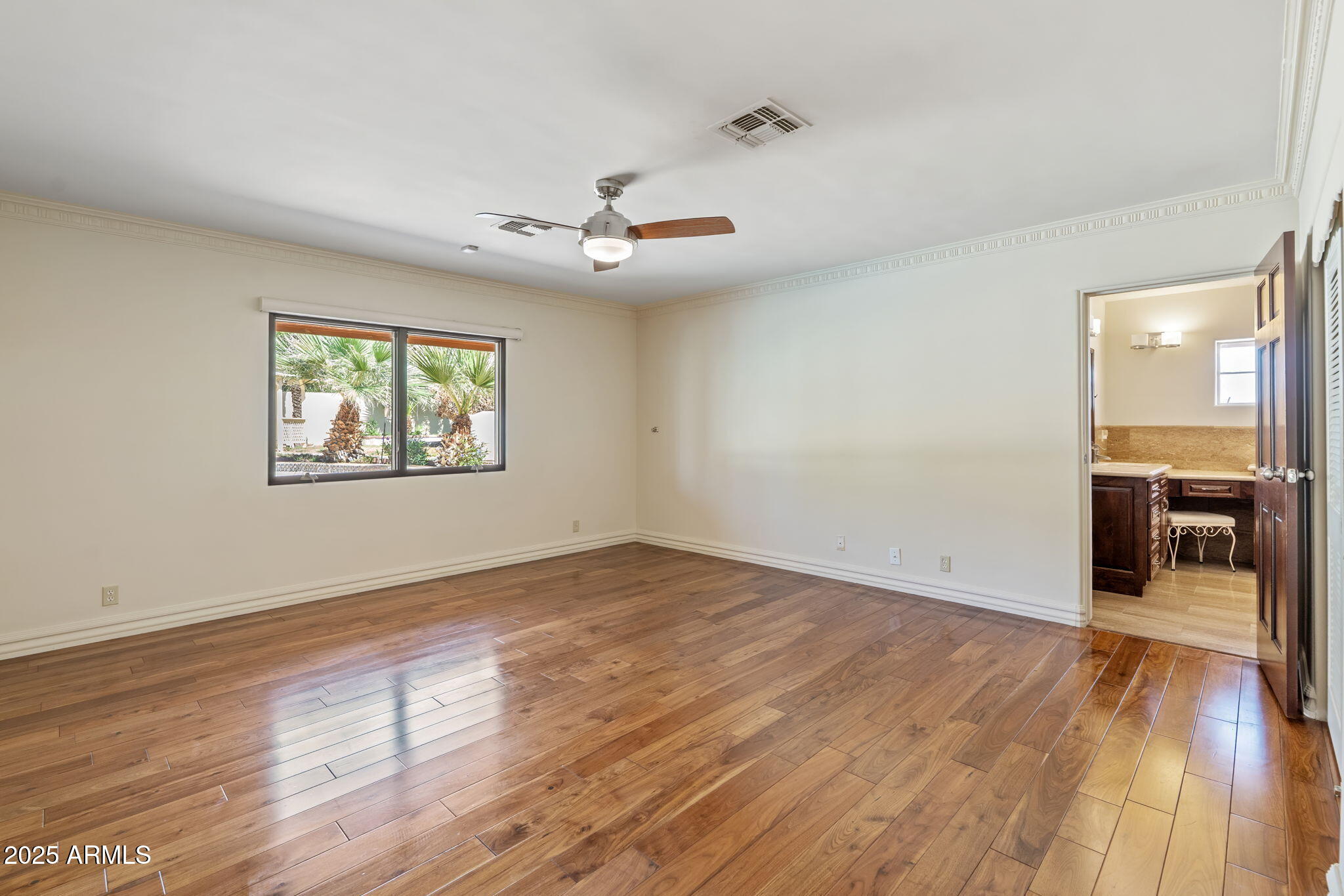 5310 East Camelback Road Phoenix, AZ 85018 - Photo 21 of 50 an empty room with wooden floor chandelier and windows
