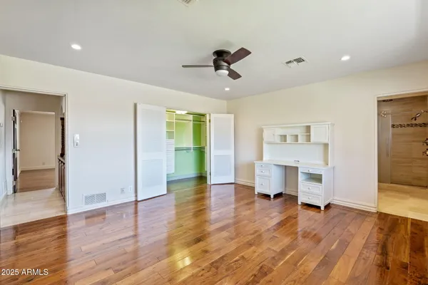 a view of empty room with a fireplace and wooden floor