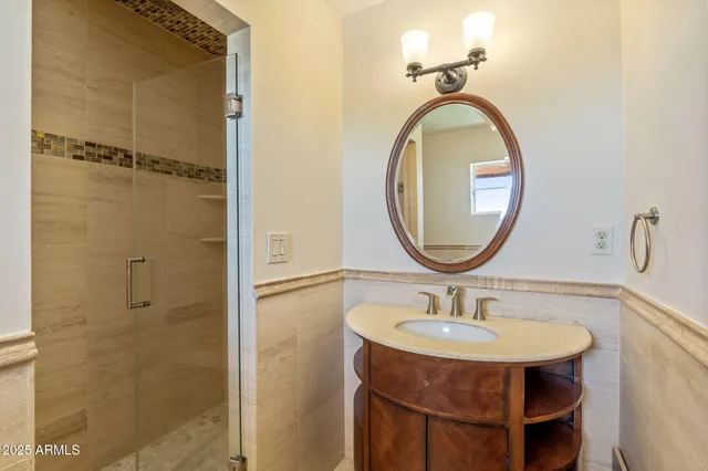 a bathroom with a sink a mirror and a shower