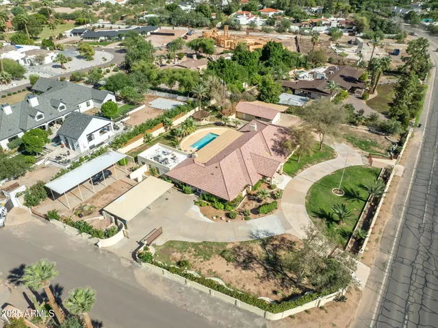 an aerial view of a house with a yard basket ball court and outdoor seating