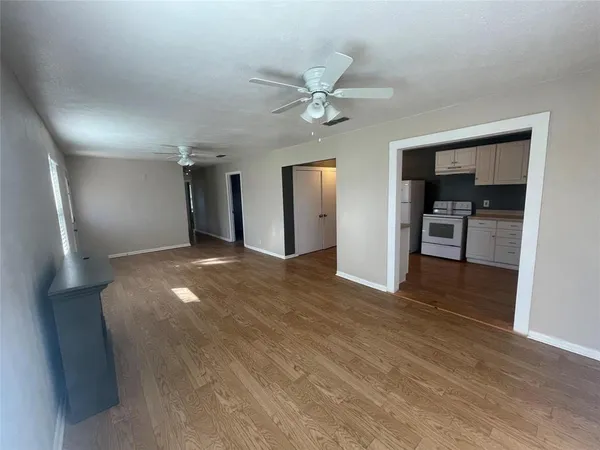 a view of a kitchen with a sink and a refrigerator