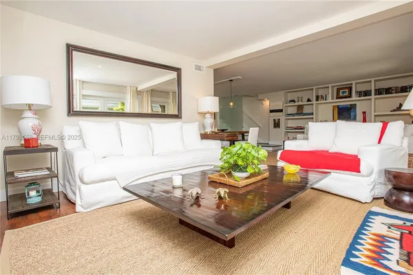 a living room with furniture and a book shelf