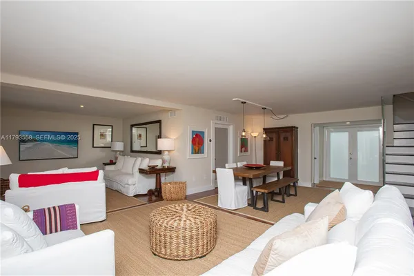 a living room with furniture kitchen view and a table