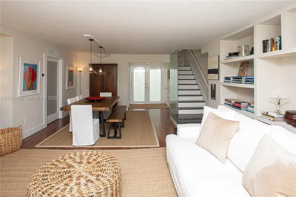 a living room with furniture and a book shelf