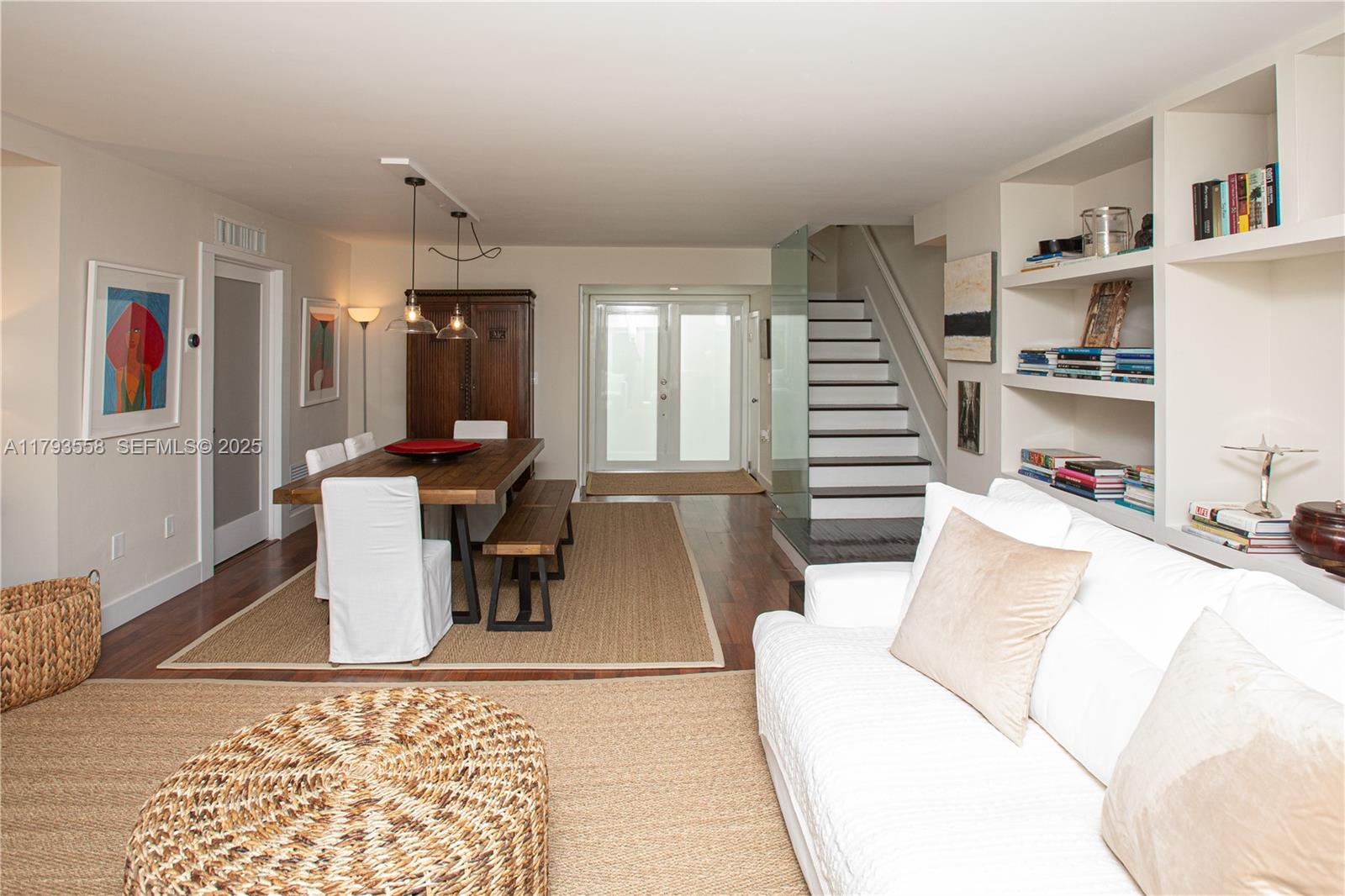 258 Seaview Drive, Unit 3 Key Biscayne, FL 33149 - Photo 6 of 14 a living room with furniture and a book shelf