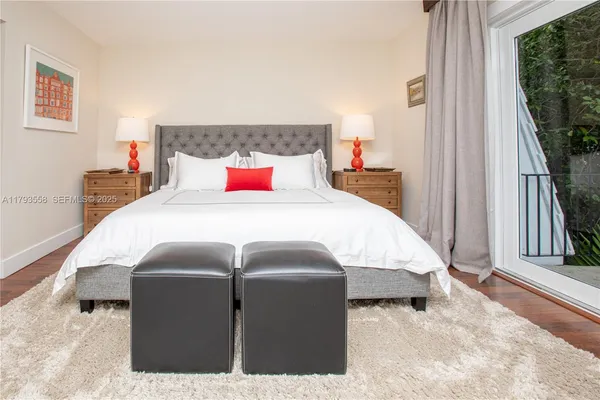 a bedroom with a bed and a large window