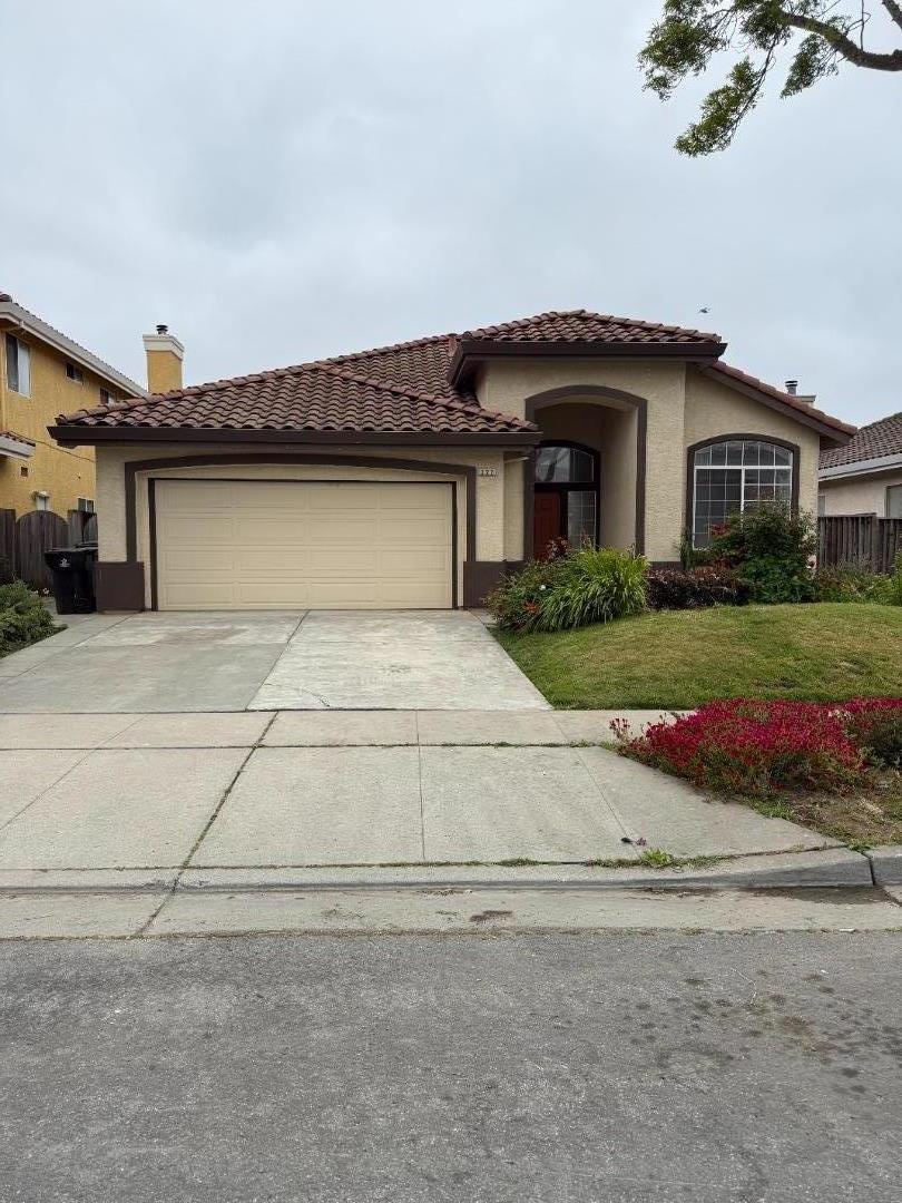 322 Riesling Way Salinas, CA 93906 - Photo 1 of 1 a front view of a house with a yard and garage