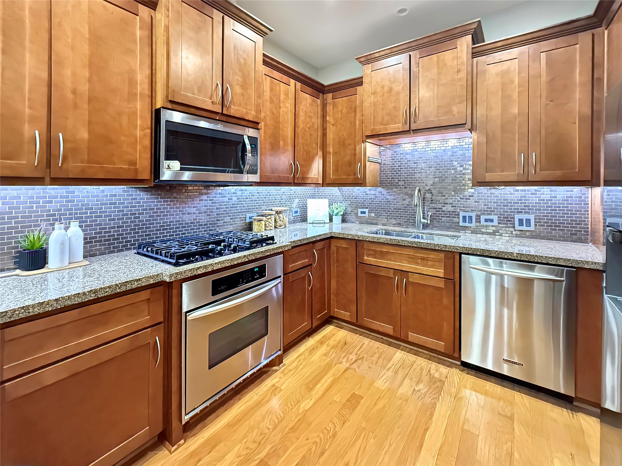 3 Waterway Court, Unit 2B Spring, TX 77380 - Photo 13 of 46 a kitchen with stainless steel appliances granite countertop wooden cabinets and a stove top oven